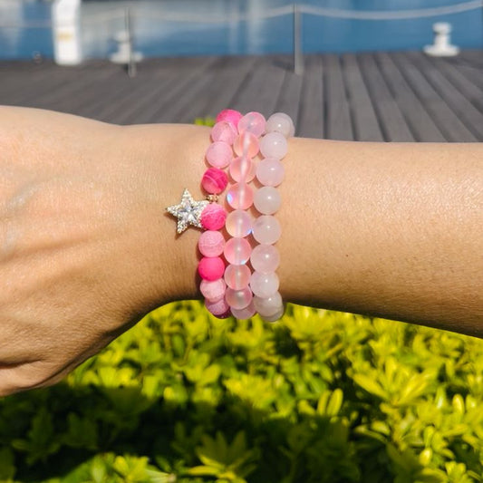 3 pink beaded bracelets with a star